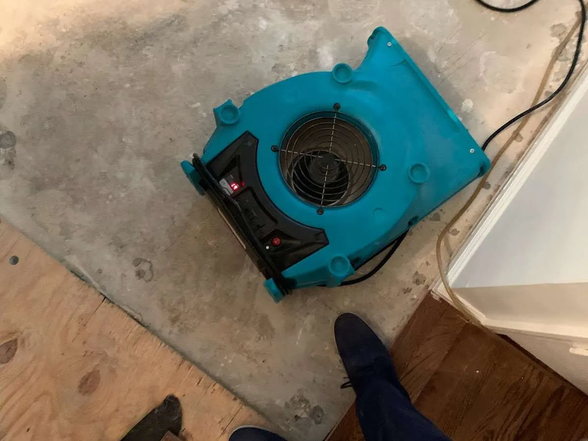Air mover drying subfloor during Leak Detection & Repair in Prairie du Chien